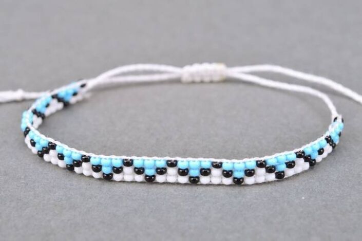 A bracelet made of thread and beads is a talisman that will bring good luck to the owner